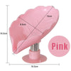 Pink leaf-shaped suction cup soap dish with a self-draining tray and stand.