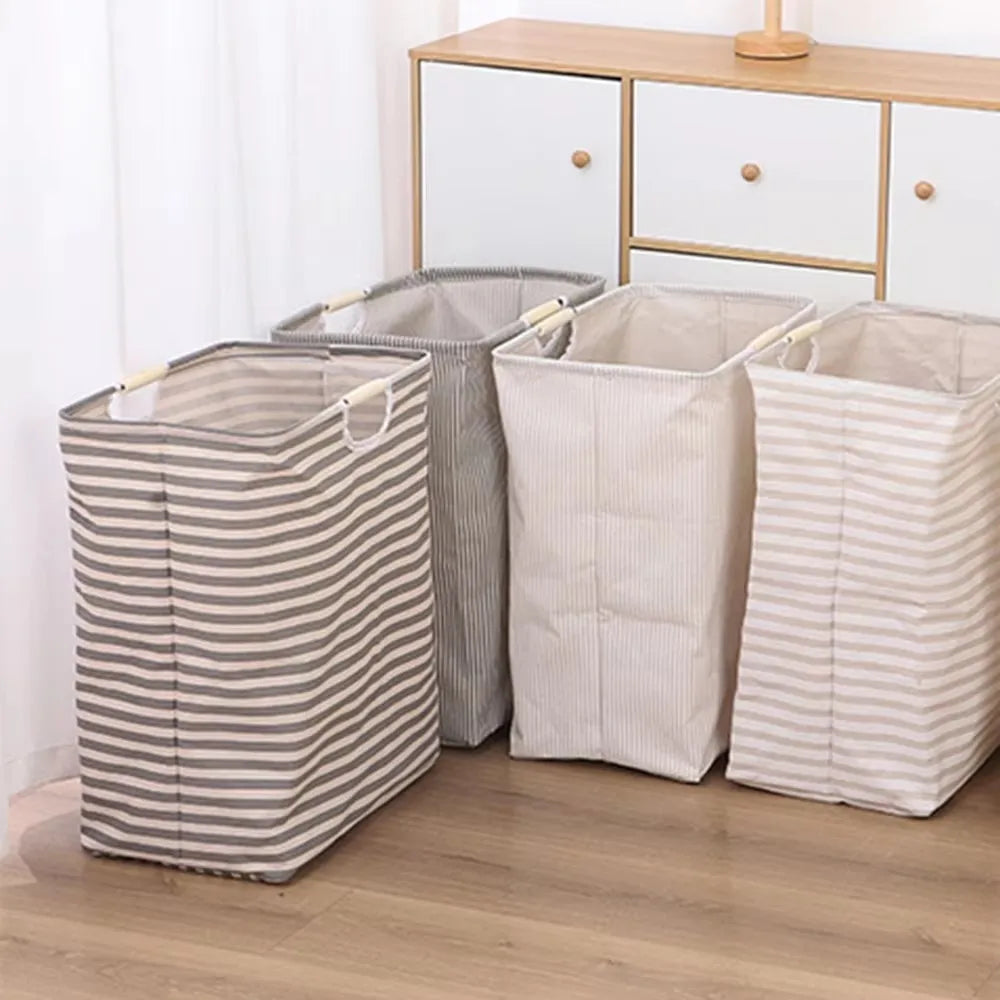 Three striped laundry baskets in beige and gray standing on a wooden floor.