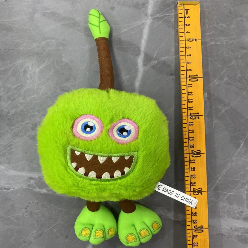 A bright green plush toy resembling a bird with large eyes and a toothy grin.
