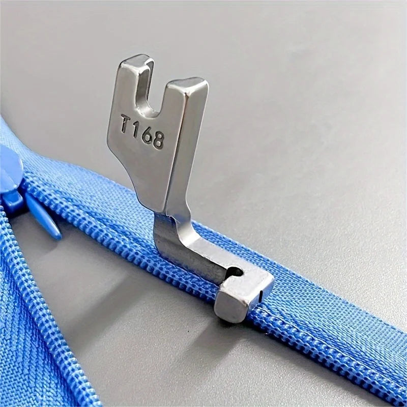 Stainless steel invisible zipper presser foot attached to a blue fabric strap.