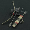A metal sword keychain and collectible ornament featuring a blade, quiver, and decorative elements on a dark background.