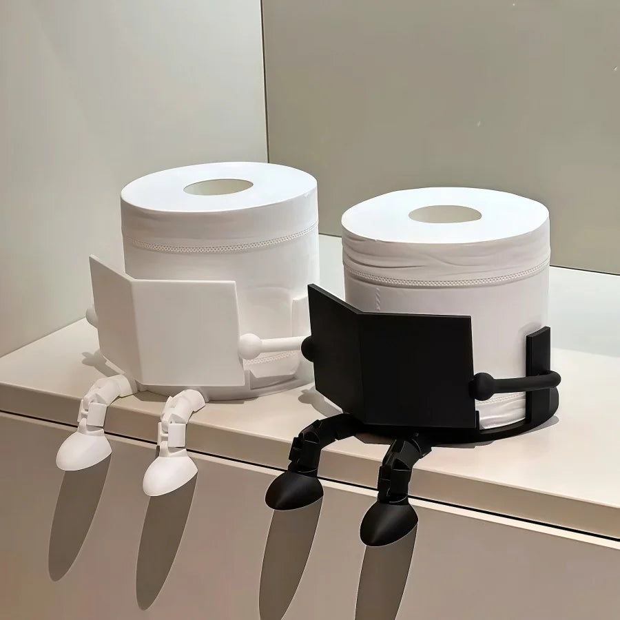 A white, human-shaped freestanding toilet paper holder with black arms and a roll of toilet paper.