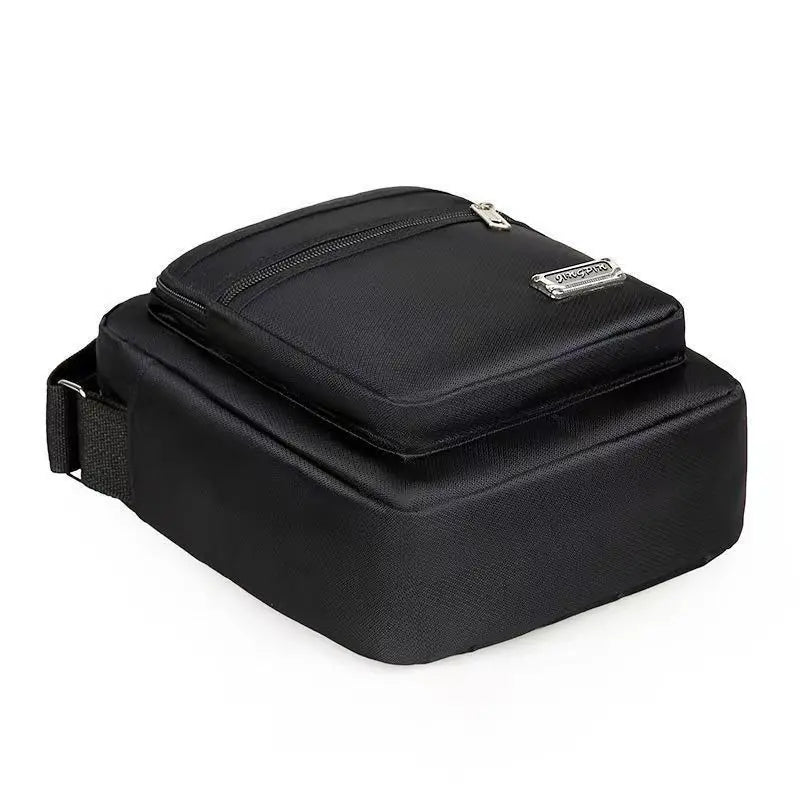 Black water-resistant multi-pocket crossbody chest bag with a zippered top pocket