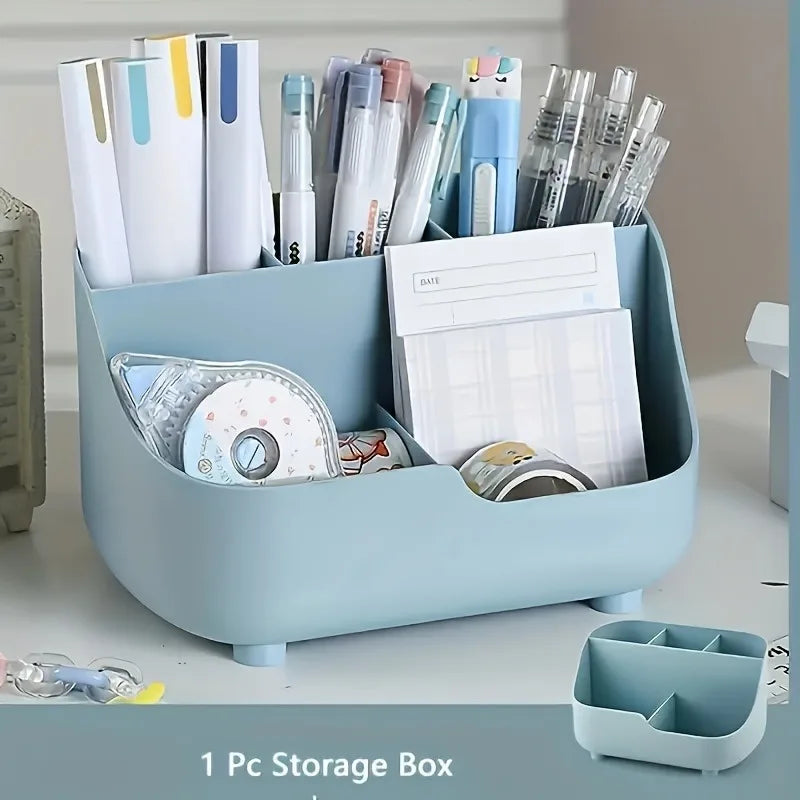 A light blue acrylic storage box filled with various pens, markers, and desk supplies.