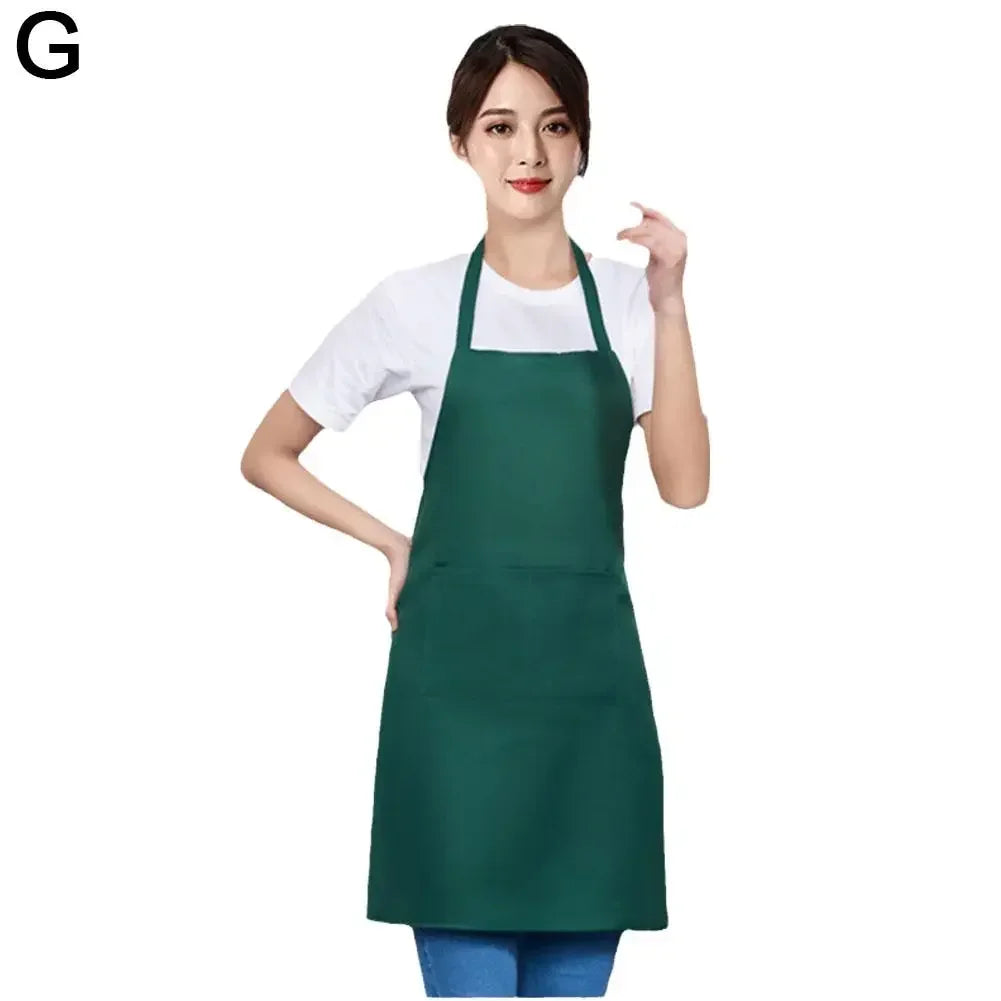 A woman wearing a dark green waterproof apron with a front pocket.