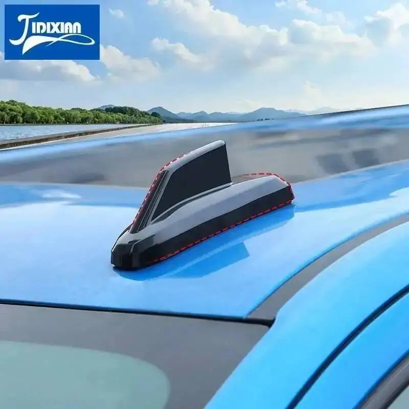 Chrome-style antenna cover trim installed on a blue vehicle's roof.