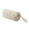 A beige quilted storage bag for a portable hair dryer and styling tool.