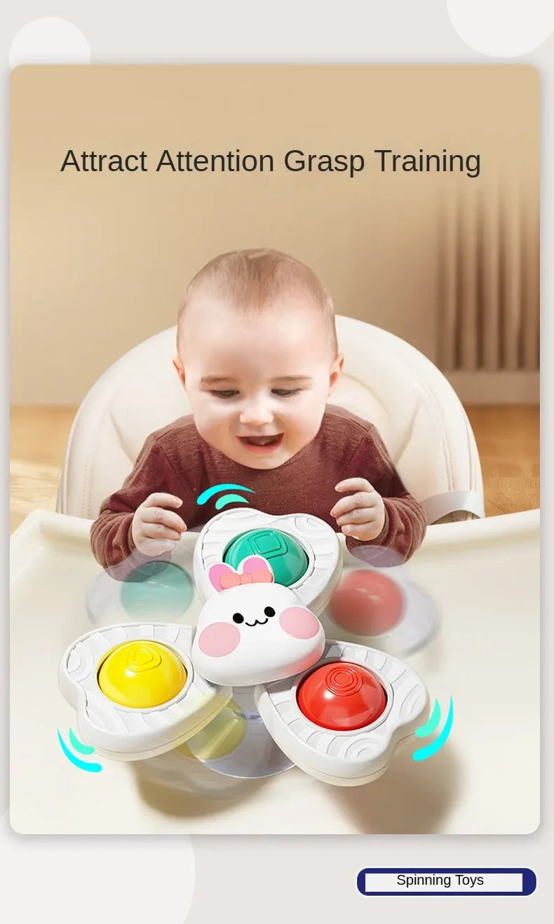 A baby is interacting with a set of spinning bath toys, including water wheels and a round toy.