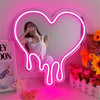 A neon sign shaped like a melting heart illuminates a pink room, featuring a woman posing in front of it.