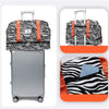 A black and white animal print duffle bag with orange straps and a silver suitcase visible in various views.