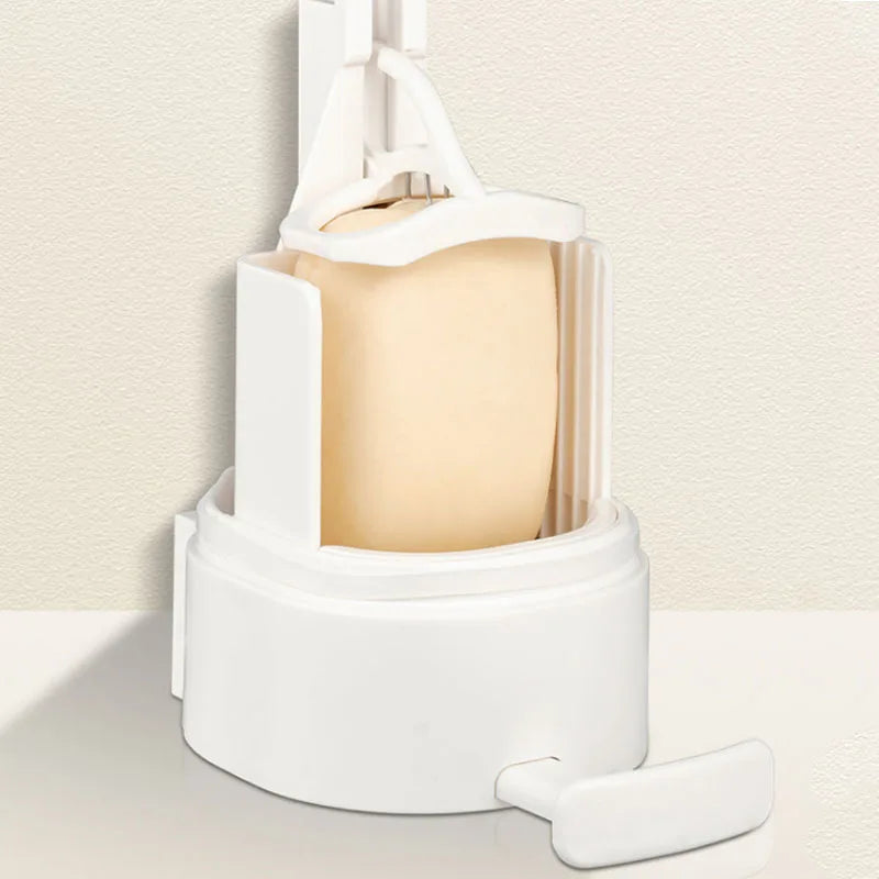 A white soap bar grinder and dispenser with a wall-mount option is shown on a light surface.
