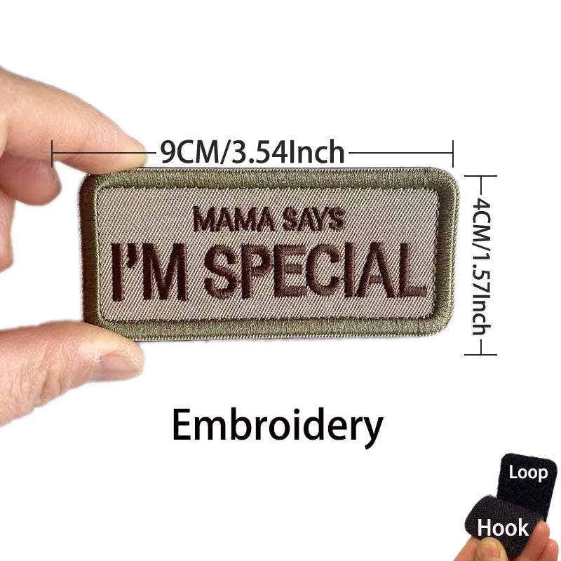 A rectangular embroidered patch with the text Mama Says I'm Special on a fabric background.
