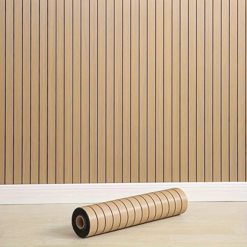 A roll of beige self-adhesive foam wall panels for decorative tiles resting on a light wooden floor.