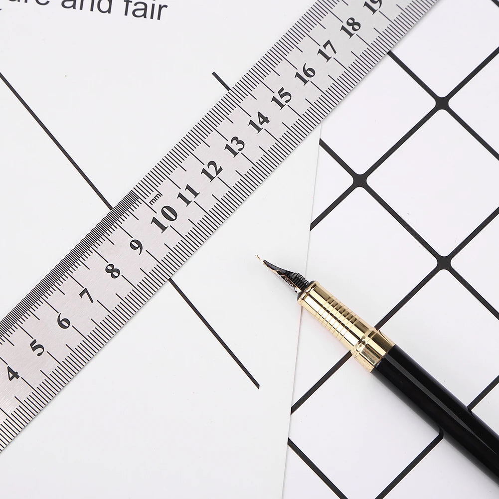 A black pen is placed next to a stainless steel precision straight ruler marked in millimeters.