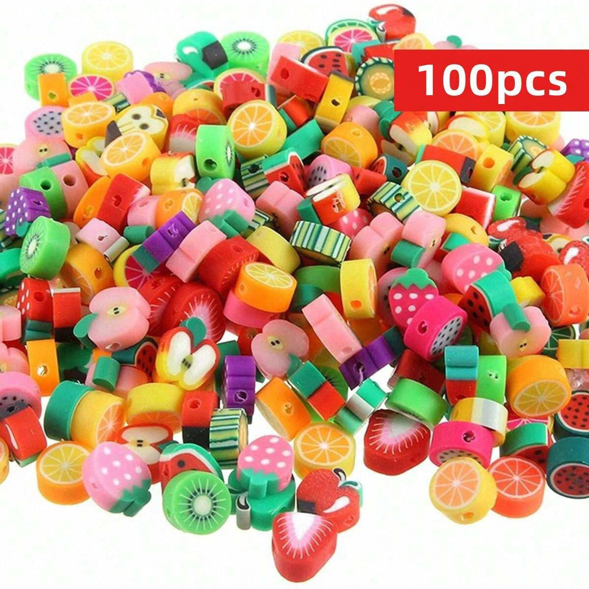 A large pile of assorted polymer clay beads shaped like summer fruits in various colors and sizes for jewelry making
