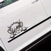 A black vinyl sticker of a cow's head peeking out from a white car door.