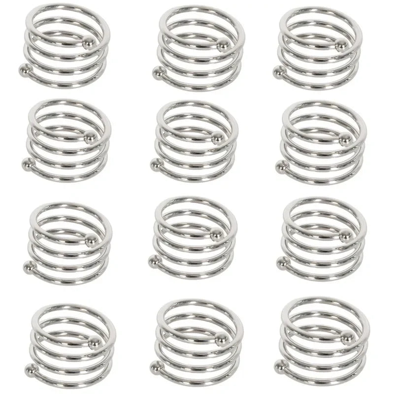 A set of twelve decorative metal napkin rings with a hollow-out pattern.