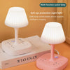 A white multi-function socket lamp with a light shade and charging ports is shown on a wooden desk.