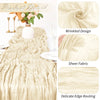 A close-up of a beige semi-sheer gauze table runner with wrinkled design and delicate edge routing.