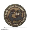 A round embroidered patch featuring a stylized figure with a beard and turban, surrounded by text in English and Arabic scrip