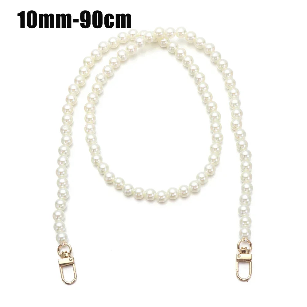 A delicate strand of white pearls used as a chain strap for bags or purses.