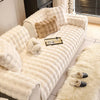A cream plush sofa cushion cover featuring quilted texture and decorative faux fur accents.
