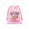 Pink drawstring storage bag featuring a graphic of a capybara and the text Just a girl who loves capybaras