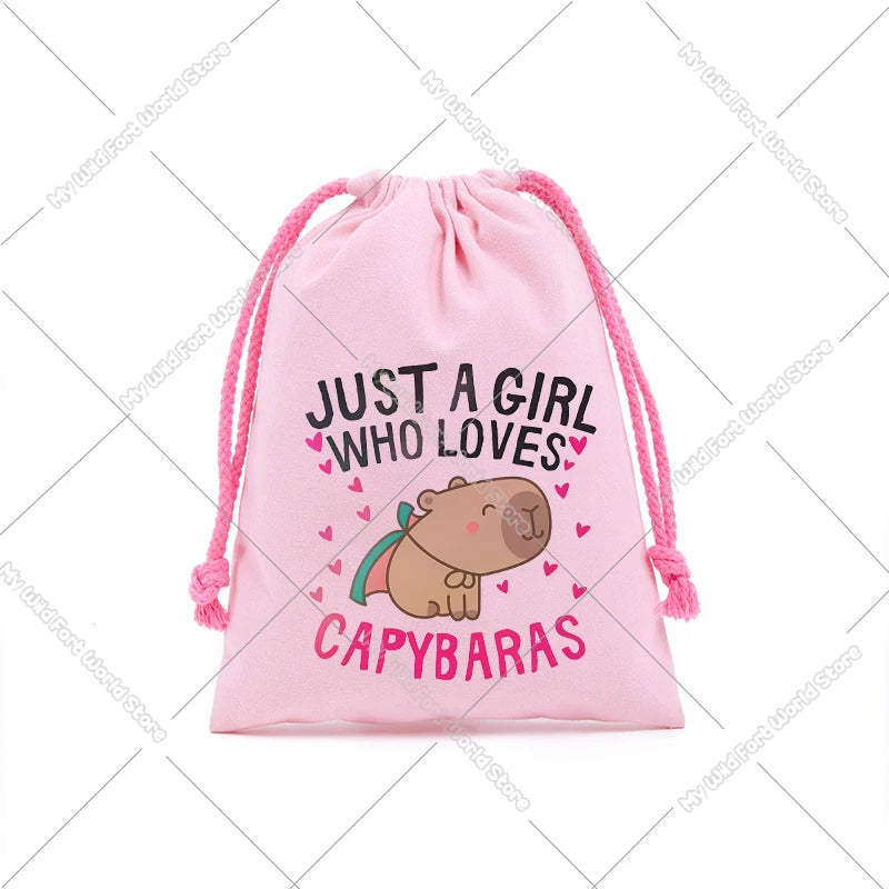 Pink drawstring storage bag featuring a graphic of a capybara and the text Just a girl who loves capybaras