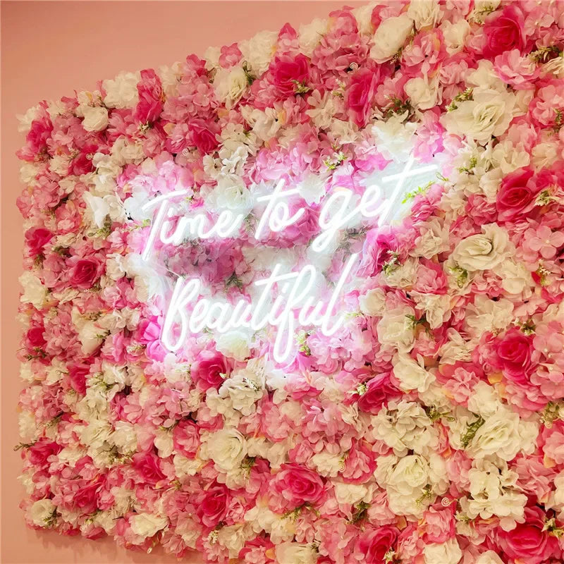 A wall panel covered in pink and white silk rose flowers with a glowing heart shape in the center.