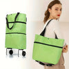 A woman holds a lime green foldable rolling shopping bag with black straps and wheels.