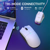 A white wireless gaming mouse is shown next to a laptop, illustrating tri-mode connectivity options.