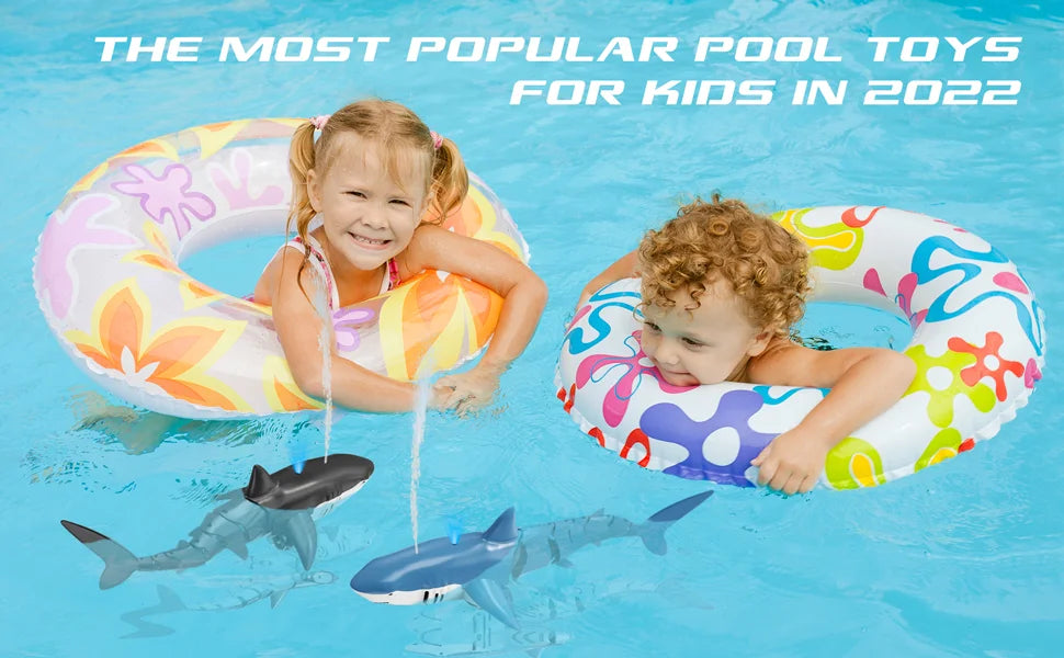 Two children floating in a pool with inflatable rings and remote control shark toys
