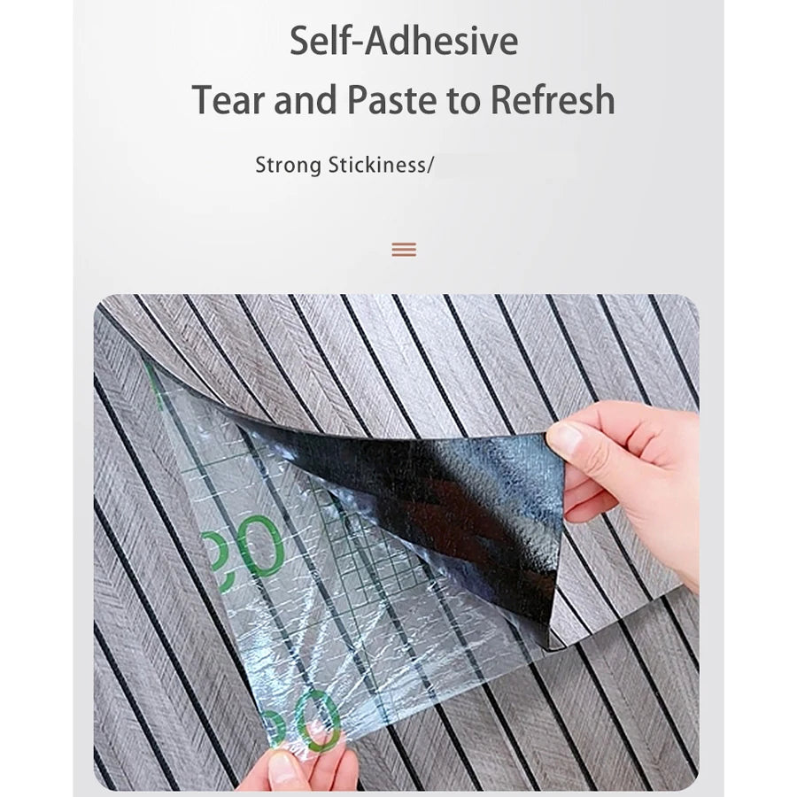 A hand is applying a clear self-adhesive tear and paste to refresh a dark, reflective panel on a wooden surface.