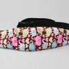 Pink and yellow elephant patterned adjustable baby car seat sleeping headrest with a black belt strap