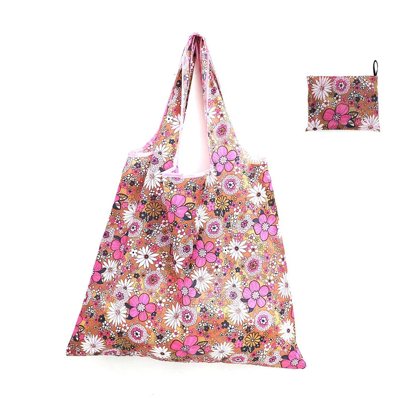 A reusable shopping tote bag featuring a floral pattern of pink, orange, and white flowers.