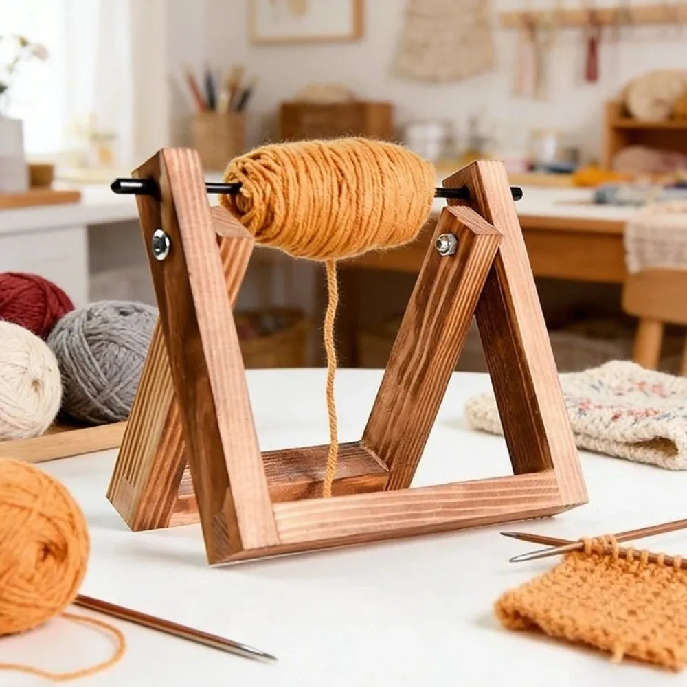 A wooden yarn ball holder with a rotating mechanism displaying a skein of golden yellow yarn.