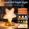 A crystal star LED night light with a gold base and touch dimming features shown on a wooden surface.