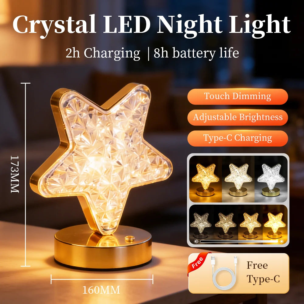 A crystal star LED night light with a gold base and touch dimming features shown on a wooden surface.