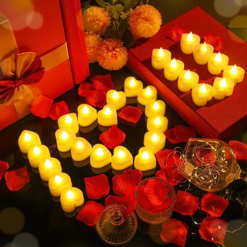 A display of heart-shaped yellow LED candles surrounded by red rose petals on a dark surface.