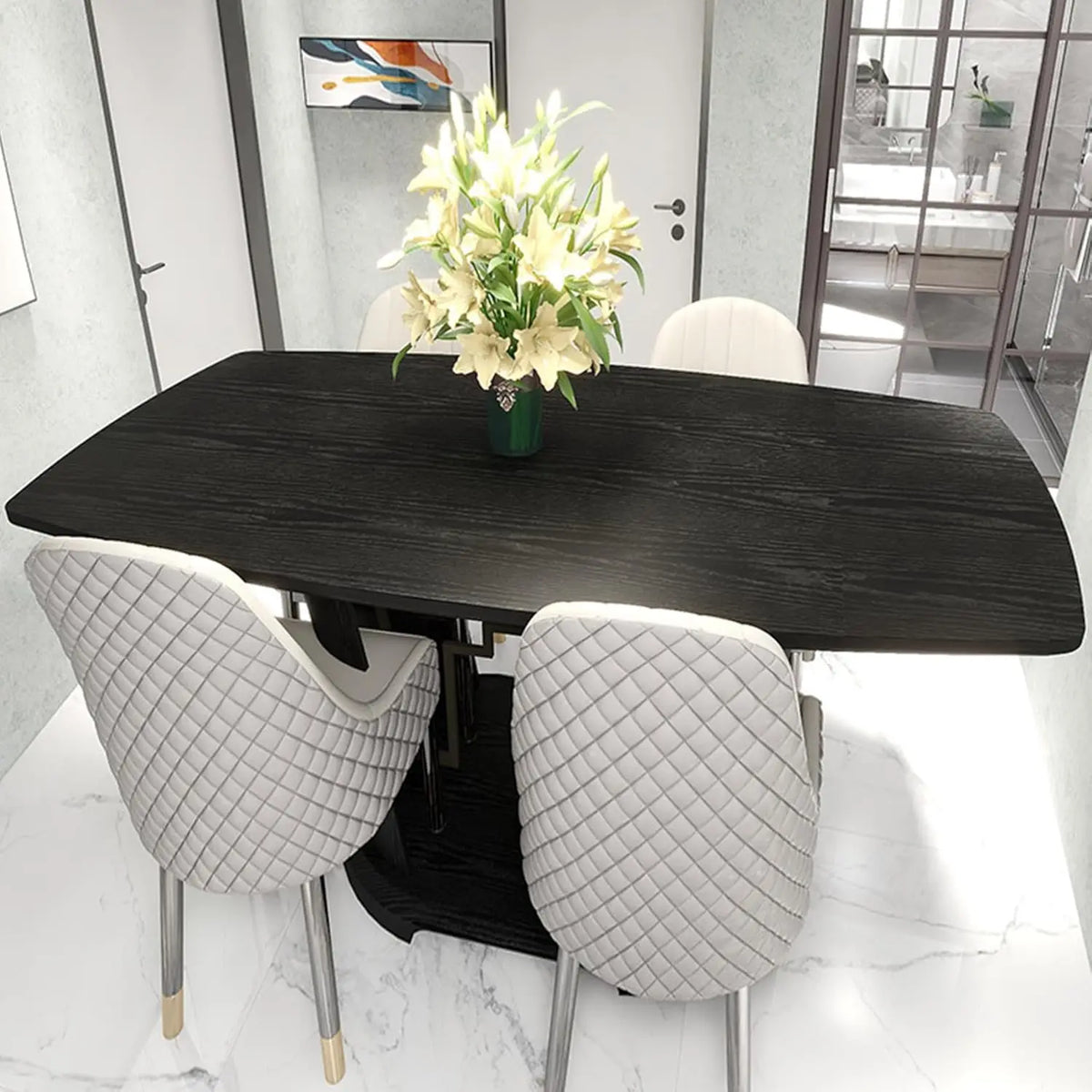 A dark wood grain table set with white upholstered chairs and a vase of white flowers.