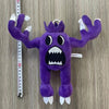 A purple plush toy of an Opila bird with spiky limbs and large teeth is displayed against a measuring tape.