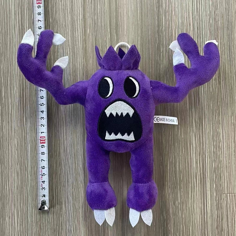 A purple plush toy of an Opila bird with spiky limbs and large teeth is displayed against a measuring tape.