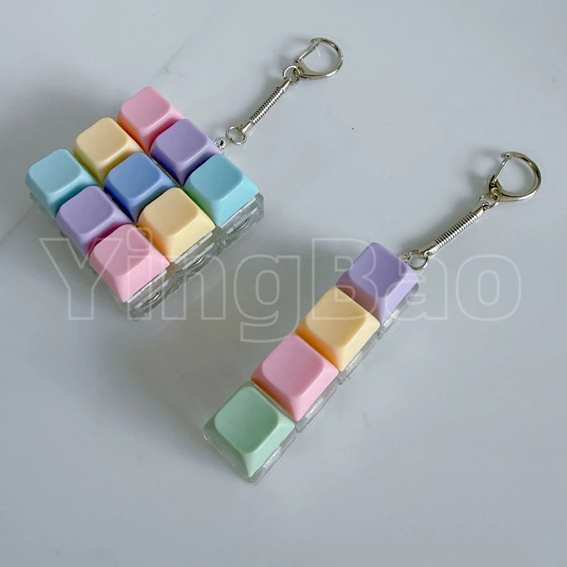 A colorful LED macaron keyboard fidget toy keychain featuring square silicone pieces in pastel shades.