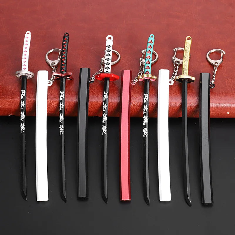 A collection of nine miniature metal katana replicas with various colored hilts and sheaths displayed on a brown leather back