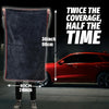 A person holds a dark gray microfiber drying towel, demonstrating its size against a red car.