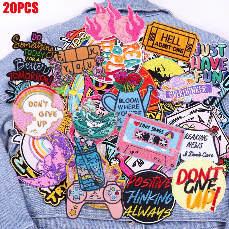 A collection of colorful embroidered patches featuring positive phrases like Hell Admit One Just Have Fun and Don't Give Up