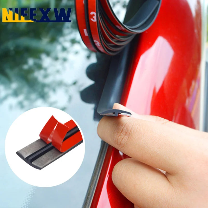 A hand is applying a black rubber seal strip to a red car window or sunroof.