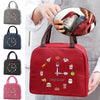 A red insulated lunch bag featuring various food icons and a fork, shown being held by a person.