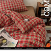 A close-up of a red plaid duvet cover set featuring a tartan pattern on a bed.