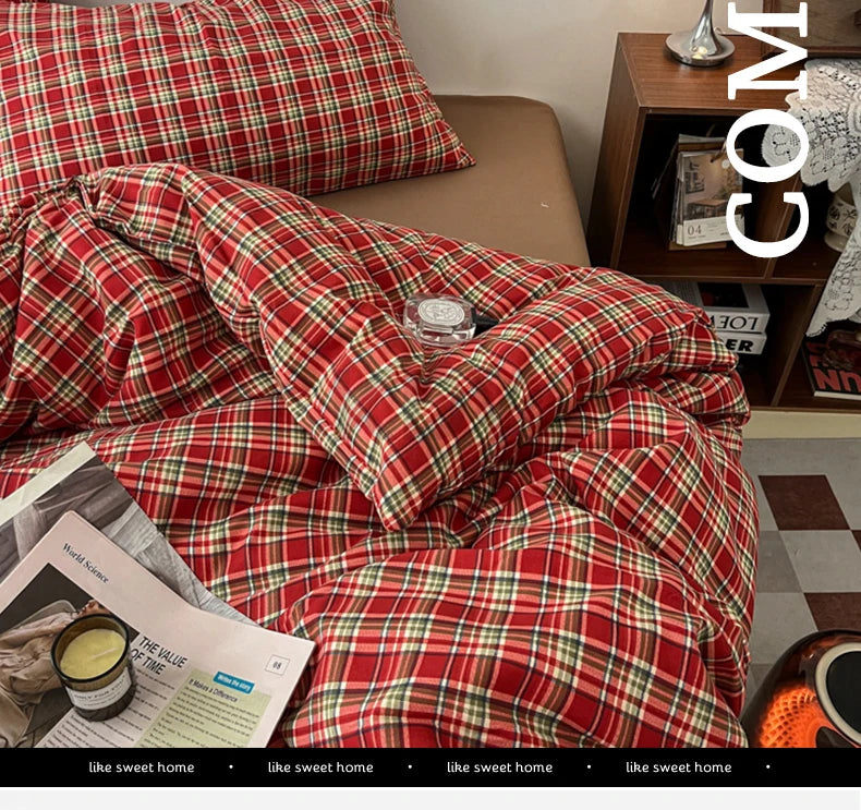 A close-up of a red plaid duvet cover set featuring a tartan pattern on a bed.